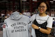 An employee shows a Nike's jacket for USA Olympic 2012 team which was produced by Maxport garment company at its headquarters in Hanoi