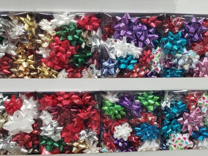 stacks of Clear packages of multi-colored gift bows at Costco