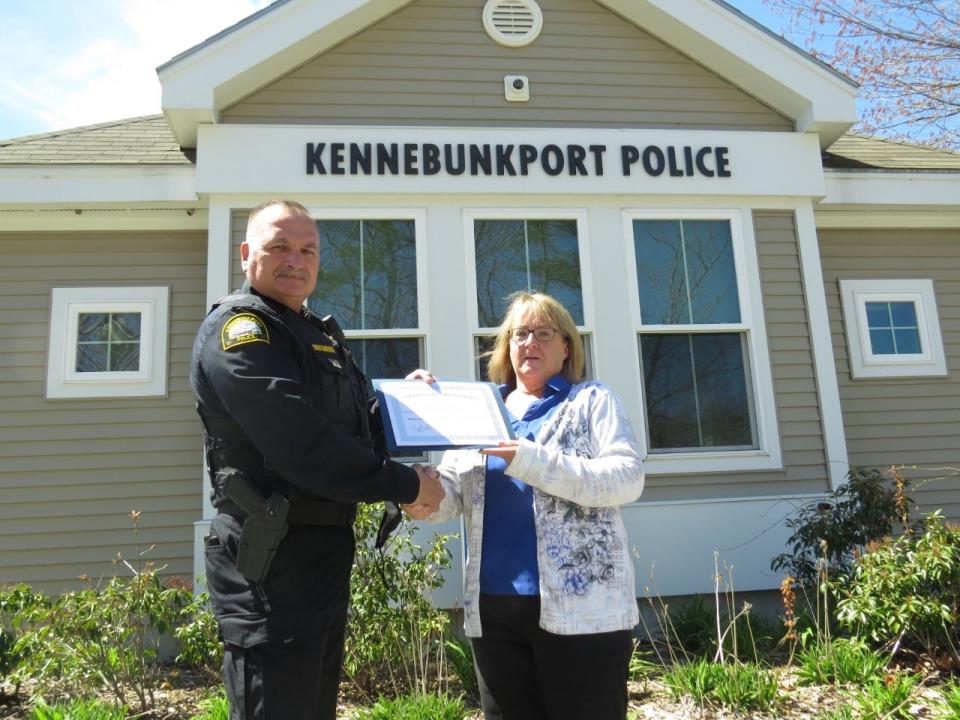 Linda McDonald, right, of Lyman, is honored by Kennebunkport Police Chief Craig Sanford for turning in a large amount of money as well as some personal property that she recently found while walking on a local beach.