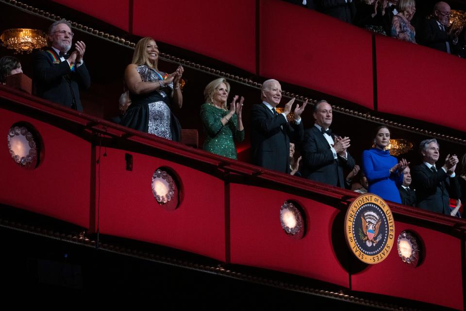 President Joe Biden, fourth from left, first lady Jill Biden, third from left, Doug Emhoff, third from right, the spouse of Vice President Kamala Harris, the president's granddaughter Naomi Biden, second from right, and Secretary of State Antony Blinken, together with 2023 Kennedy Center Honorees, from left, actor and comedian Billy Crystal and singer and actress Queen Latifah.