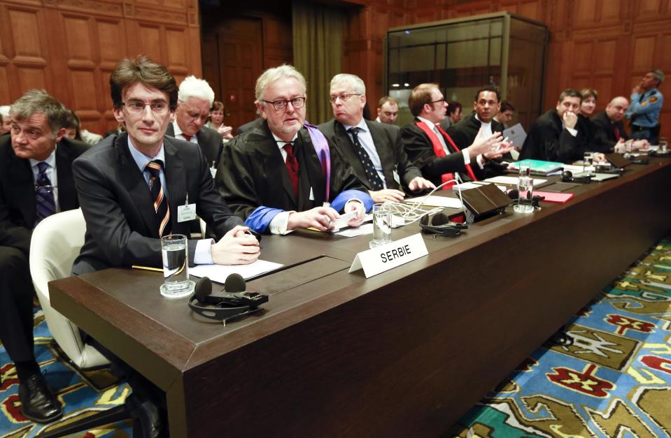 Members of the Serbian delegation, from left: Sasa Orbadovic, William Schabas, Andreas Zimmermann, Christian Tams and Wayne Jordash await the start of public hearings at the International Court of Justice (ICJ) in The Hague, Netherlands, Monday, March 3, 2014. Croatia is accusing Serbia of genocide during fighting in the early 1990's as the former Yugoslavia shattered in spasms of ethnic violence, in a case at the United Nations' highest court that highlights lingering animosity in the region. Croatia is asking the ICJ to declare that Serbia breached the 1948 Genocide Convention when forces from the former Federal Republic of Yugoslavia attempted to drive Croats out of large swaths of the country after Zagreb declared independence in 1991. (AP Photo/Jiri Buller)