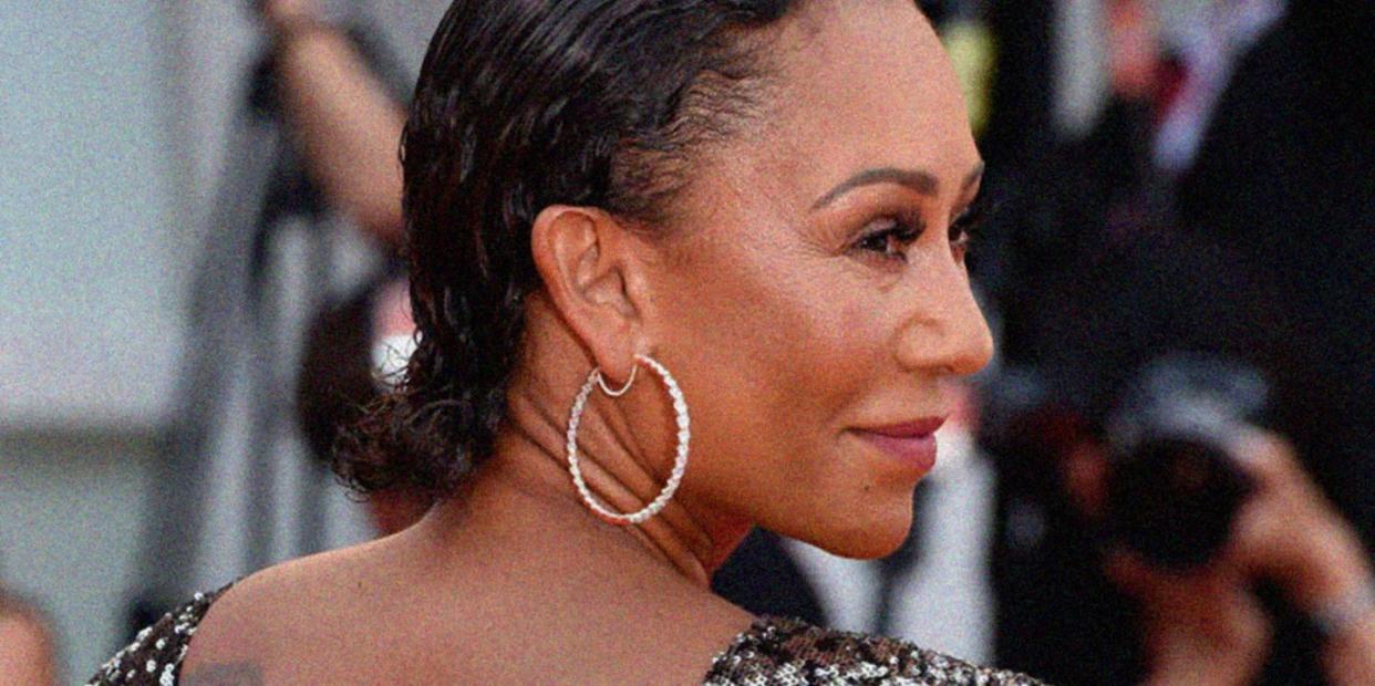 mel b pictured smiling as she turns away from the camera wearing a sequin dress on a red carpet