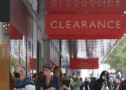 People, some wearing masks queue outside a John Lewis store, in London, Thursday, July 16, 2020. Unemployment across the U.K. has held steady during the coronavirus lockdown as a result of a government salary support scheme, but there are clear signals emerging that job losses will skyrocket over coming months. The Office for National Statistics said Thursday there were 649,000 fewer people, or 2.2%, on payroll in June when compared with March when the lockdown restrictions were imposed. (AP Photo/Alastair Grant)