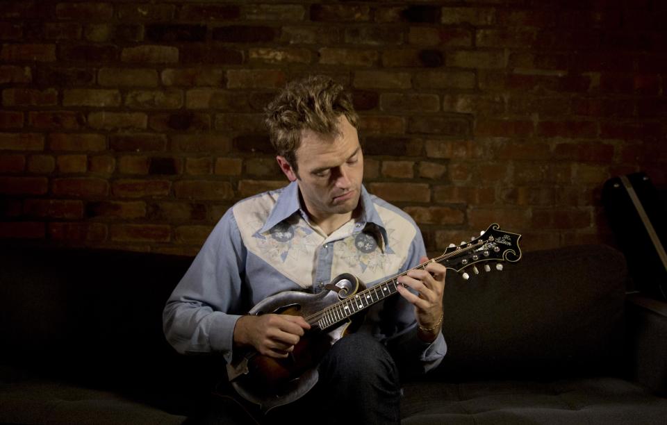 In this Sept. 17, 2012 photo provided by the Chicago-based John D. and Catherine T. MacArthur Foundation, Chris Thile, 31, a mandolinist and composer who is creating a new musical aesthetic and a distinctly American canon for the mandolin through a lyrical fusion of traditional bluegrass orchestrations with a range of styles and genres, is seen in his East Village apartment in New York. Thile is among 23 recipients of this year's MacArthur Foundation "genius grants." (AP Photo/Courtesy of the John D. and Catherine T. MacArthur Foundation, Christopher Lane)