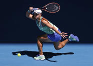 FILE - In this Jan. 30, 2020, file photo, Australia's Ashleigh Barty makes a forehand return to Sofia Kenin of the U.S. during their semifinal match at the Australian Open tennis championship in Melbourne, Australia. The heads of the ATP and WTA professional tennis tours tell the AP that they are coordinating with each other as they weigh how to reschedule the sport’s calendar for whenever play can resume after the COVID-19 pandemic. (AP Photo/Andy Wong, File)