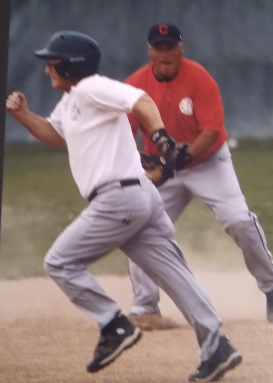 Wayne Bloodhart, is seen running bases in a Senior Division game under the watchful eye of shortstop Erv Howard.