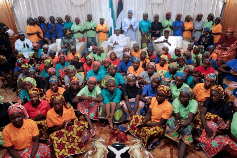 Nigeria's President Muhammadu Buhari (centre) met the 82 rescued Chibok girls after their release in a prisoner swap deal