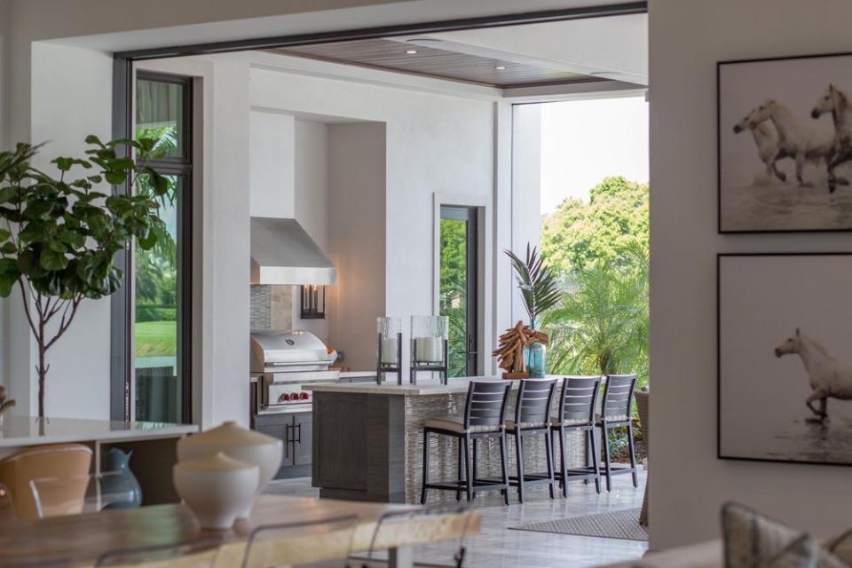 Subtle nods to a love of horses are incorporated in this Florida outdoor kitchen.