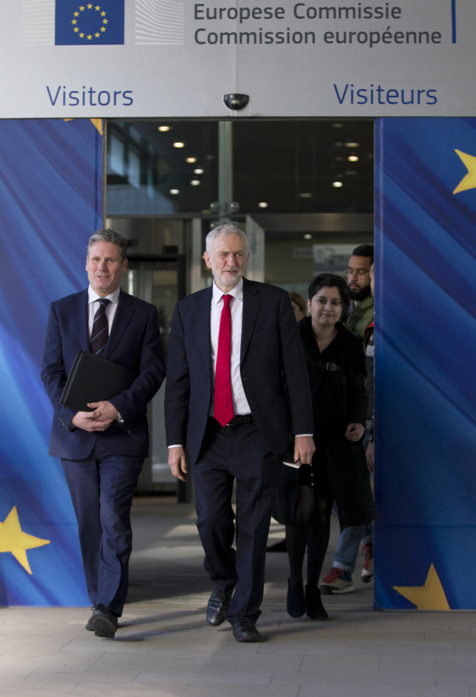 British Labour Party leader Jeremy Corbyn, right, and shadow Brexit Secretary Keir Starmar leave EU headquarters in Brussels, Thursday, Feb. 21 2019. Corbyn is in Brussels to meet European Union chief Brexit negotiator Michel Barnier. (AP Photo/Virginia Mayo)