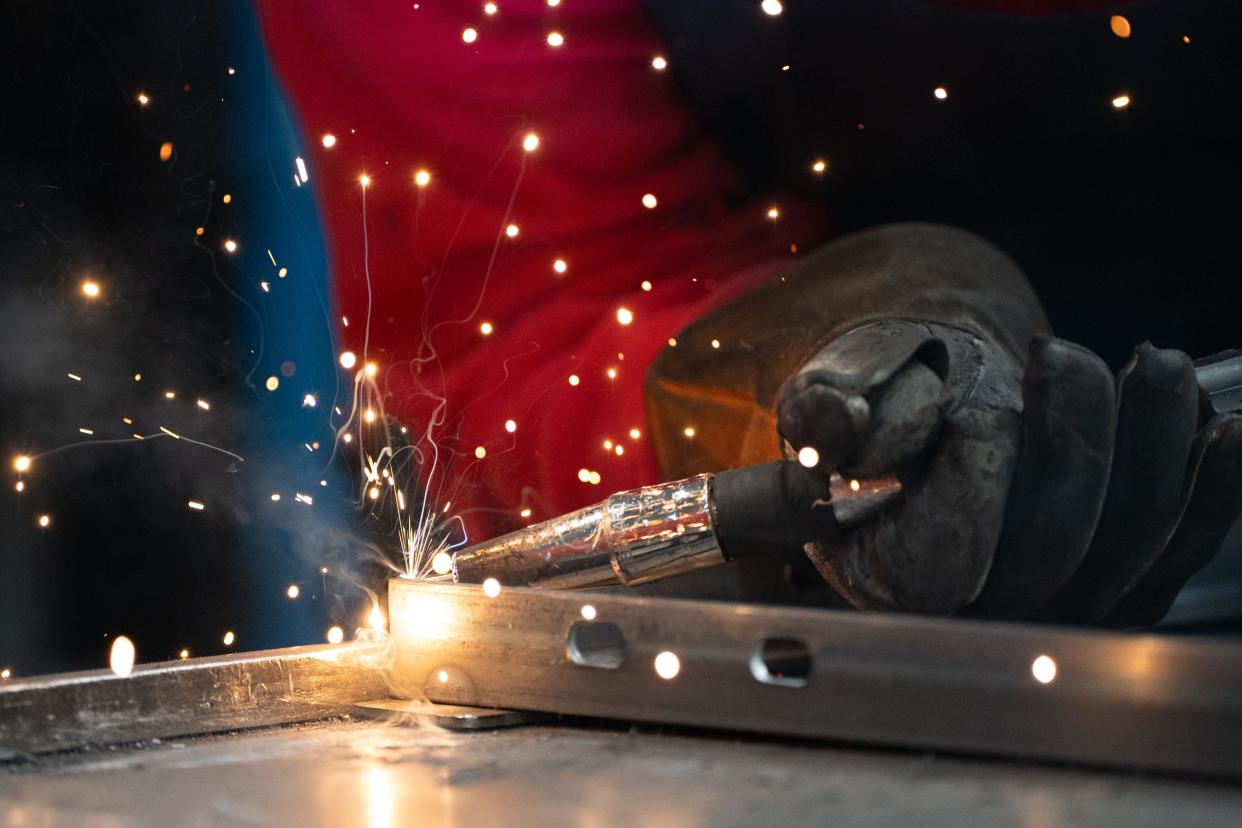 Danielle Roberts welds together two pieces of metal during her shift at Wire Cutters on Wednesday, March 20, 2024.