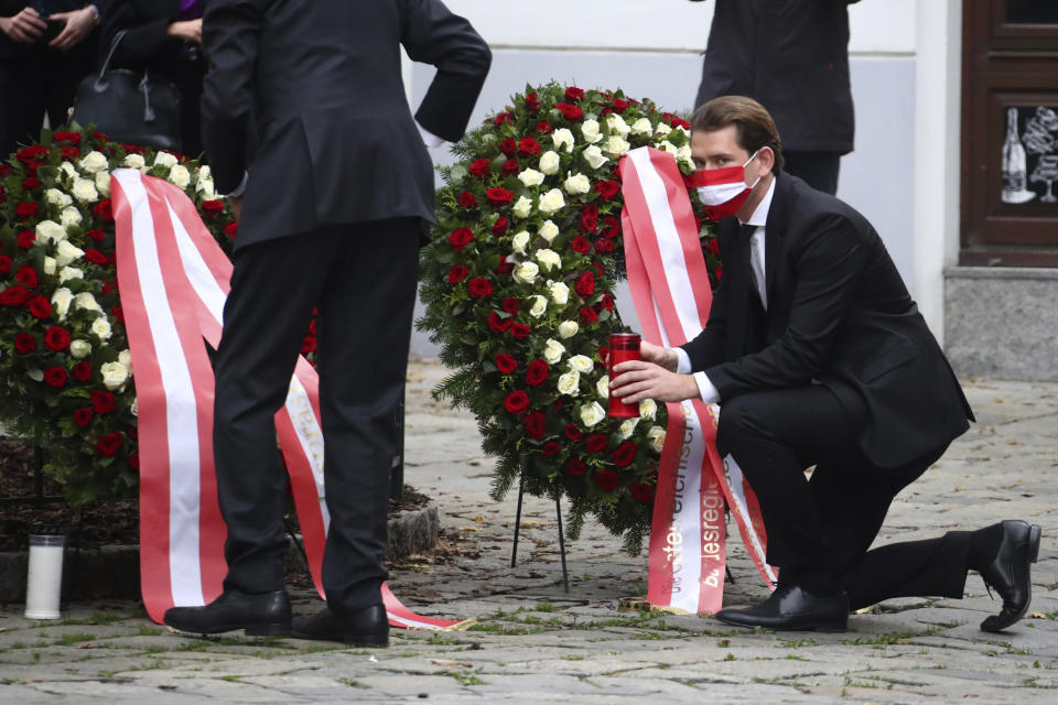 Austria Chancellor Sebastian Kurz, right, and President Alexander van der Bellen lay down a wreath in Vienna, Austria, Tuesday, Nov. 3, 2020. Police in the Austrian capital said several shots were fired shortly after 8 p.m. local time on Monday, Nov. 2, in a lively street in the city center of Vienna. Austria's top security official said authorities believe there were several gunmen involved and that a police operation was still ongoing. (AP Photo/Matthias Schrader)