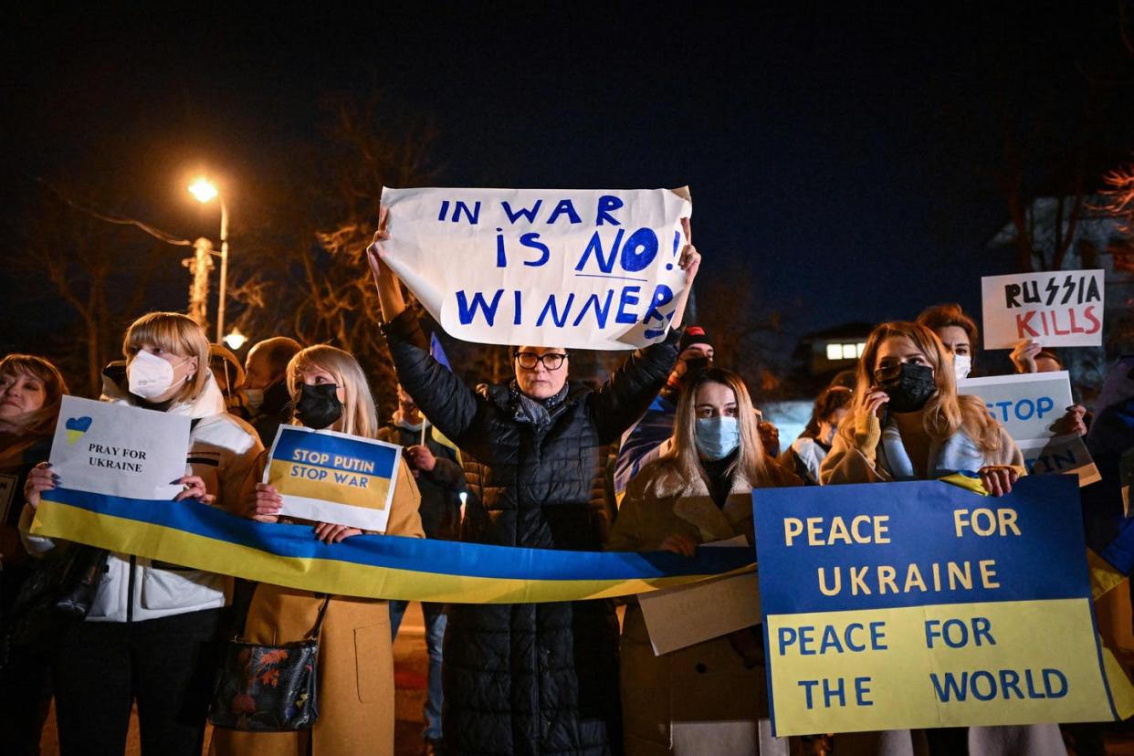 <span class="caption">People protest in front of Ukraine's embassy to Romania in Bucharest on Feb. 24, 2022. </span> <span class="attribution"><a class="link " href="https://media.gettyimages.com/photos/people-take-part-in-a-rally-for-ukraine-in-front-of-ukraines-embassy-picture-id1238731351?s=2048x2048" rel="nofollow noopener" target="_blank" data-ylk="slk:Daniel Mihailescu/AFP via Getty Images;elm:context_link;itc:0;sec:content-canvas">Daniel Mihailescu/AFP via Getty Images</a></span>