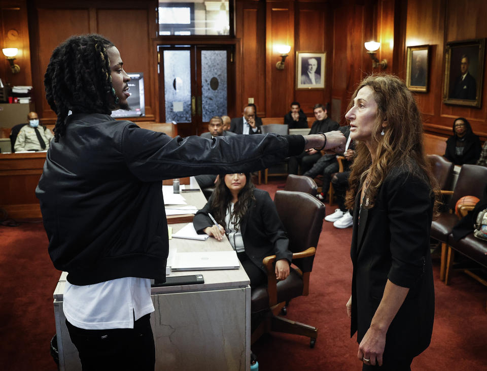 Memphis Grizzlies player Ja Morant, left, demonstrates to attorney Rebecca Adelman, right, how he threw a punch during a fight, while testifying in Judge Carol Chumney's courtroom at Shelby County Circuit Court Monday, Dec. 11, 2023, in Memphis, Tenn. The hearing is to determine whether Morant used self defense during a fight last summer at his home. (Mark Weber/Daily Memphian via AP)