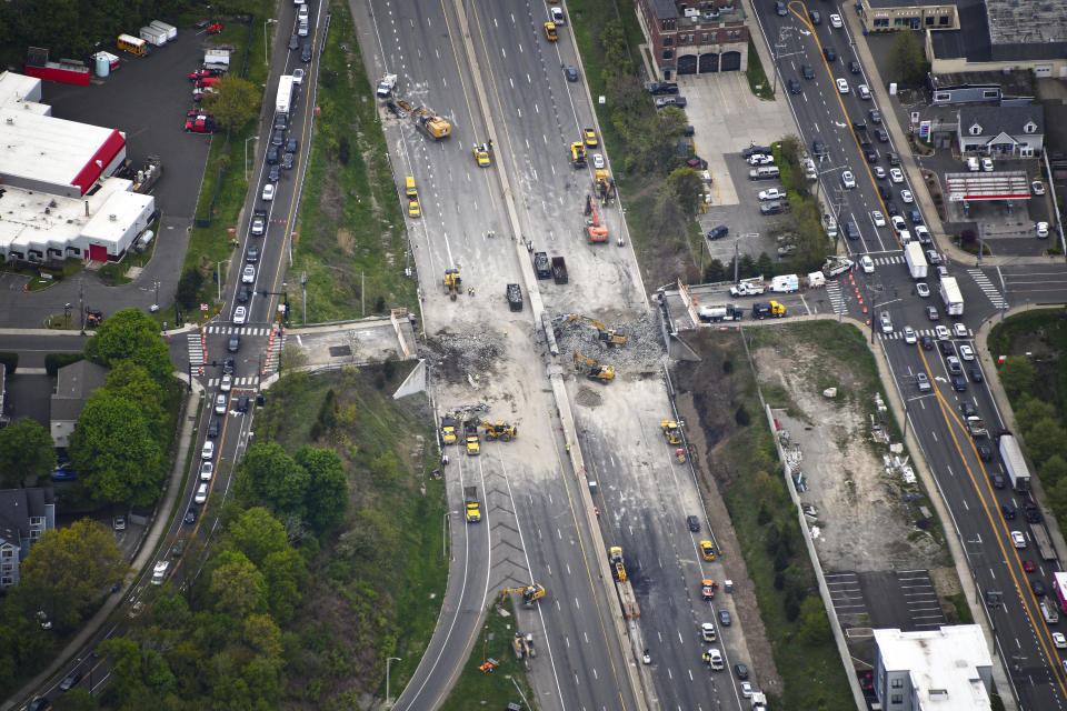 This aerial view looking south shows demolition crews working to finish removing the Fairfield Avenue bridge over Interstate 95, Saturday, May 4, 2024 in Norwalk, Conn. Crews are expected to finish removing the bridge by Sunday morning, and road repairs will be made. The tanker truck burst into flames under the overpass after colliding with two other vehicles Thursday. The cause remains under investigation. (Kevin Coughlin / All Island Aerial via AP)