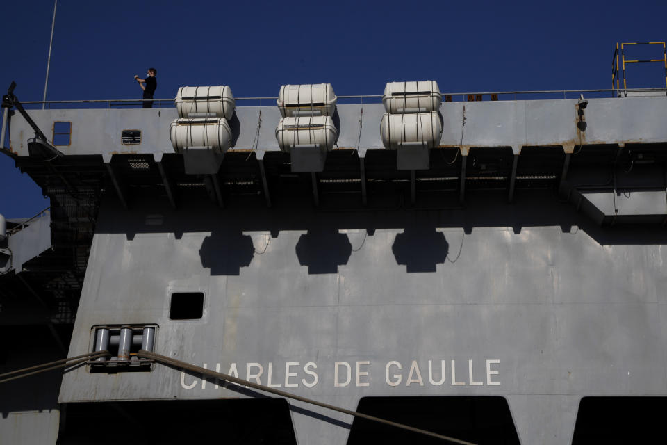 A French crew member stands at France's nuclear-powered aircraft carrier Charles de Gaulle at Limassol port, Cyprus, Monday May 10, 2021. With the Task Force's deployment on its mission named "Clemenceau 21," France is assisting in the fight against terrorism while projecting its military power in regions where it has vital interests. (AP Photo/Petros Karadjias)