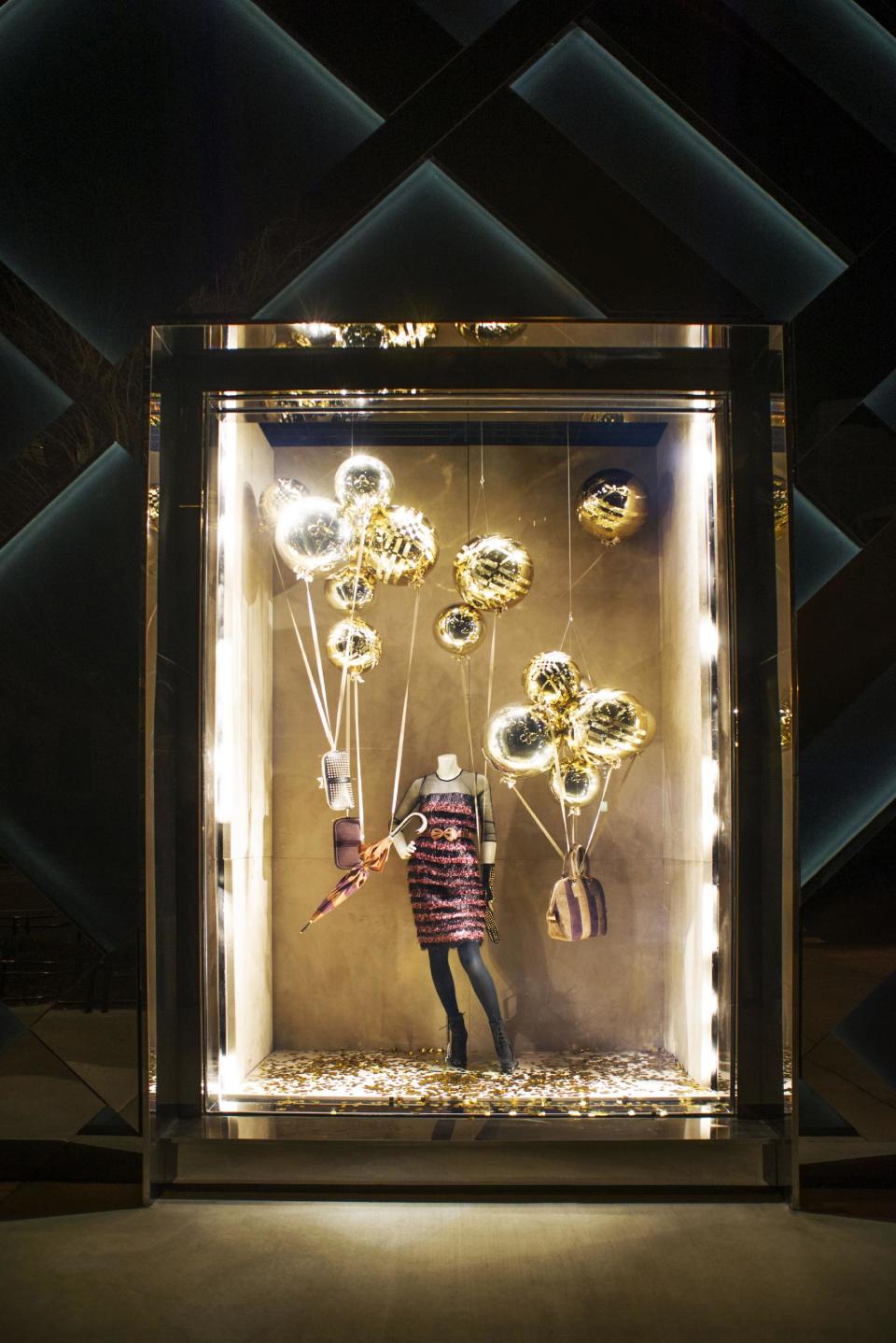 This undated publicity photo provided by BURBERRY shows a window display on the exterior of the new BURBERRY Flagship store opened in November 2012 on Michigan Avenue in Chicago. BURBERRY has been known for generations for its signature check pattern and trenchcoat. But it's been chief executive officer, Angela Ahrendts, and chief creative officer, Christopher Bailey, who have pushed the brand's digital, and now mobile, boundaries. (AP Photo/BURBERRY)