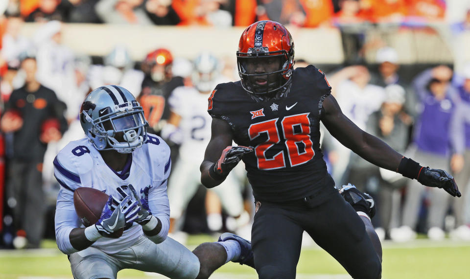 Kansas State defensive back Duke Shelley (8) intercepts a pass intended for Oklahoma State wide receiver James Washington (28) in the first half of an NCAA college football game in Stillwater, Okla., Saturday, Nov. 18, 2017. (AP Photo/Sue Ogrocki)