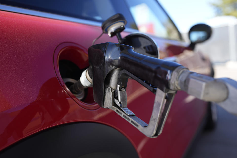 A motorist fills up the fuel tank of a vehicle at a Shell station Friday, Nov. 17, 2023, in Englewood, Colo. A big explanation for the recent decline in gas prices is seasonality — with prices at the pump almost always easing at this time of year. (AP Photo/David Zalubowski)