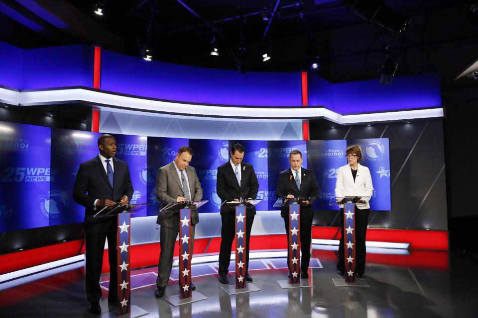 Democratic gubernatorial candidates, from left, Andrew Gillum, Jeff Greene, Chris King, Philip Levine and Gwen Graham await the start of a debate ahead of the Democratic primary for governor, Thursday, Aug. 2, 2018, in Palm Beach Gardens, Fla. (AP Photo/Brynn Anderson)