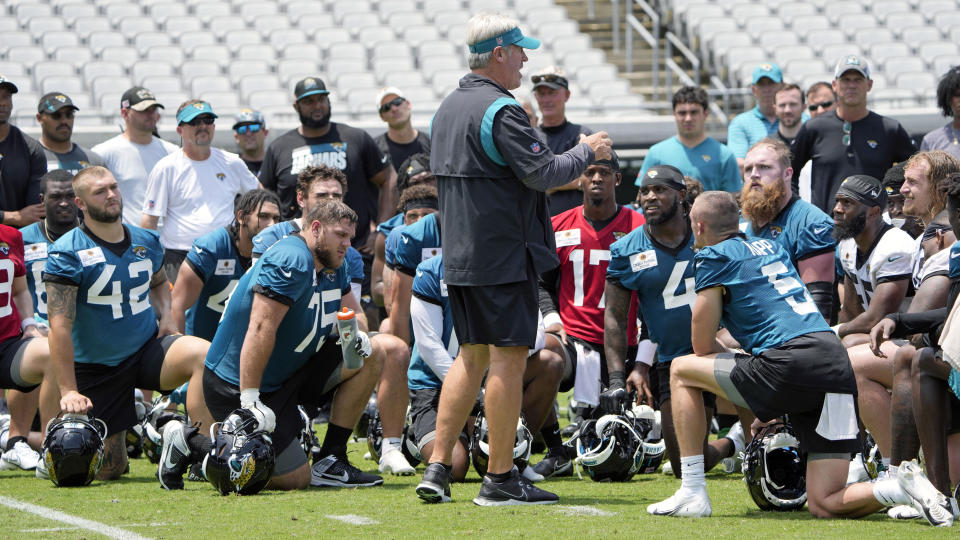 Jacksonville Jaguars head coach Doug Pederson, center, talks to players at the end of the first day of an NFL football rookie camp, Friday, May 12, 2023, in Jacksonville, Fla. (AP Photo/John Raoux)