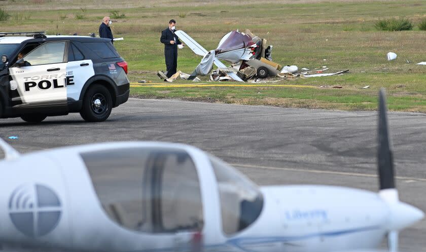 Torrance, California November 30, 2022-Investigators look over a plane that crashed and killed two people at Torrance Airport Wednesday morning. (Wally Skalij/Los Angeles Times)