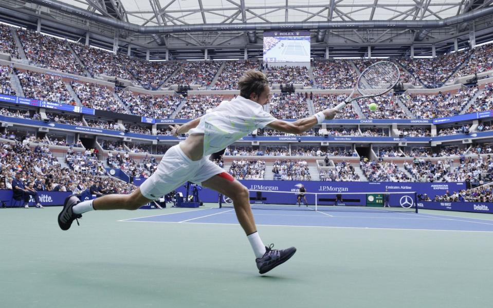 Daniil Medvedev of Russia hits a return to Rafael Nadal of Spain during the men's final match on the fourteenth day of the US Open - REX