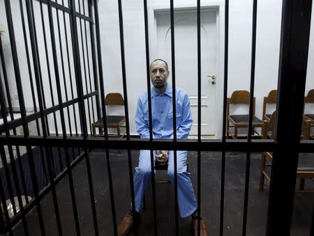 Saadi Gaddafi, son of Muammar Gaddafi, sits behind bars during a hearing at a courtroom in Tripoli, Libya November 1, 2015. REUTERS/Ismail Zitouny