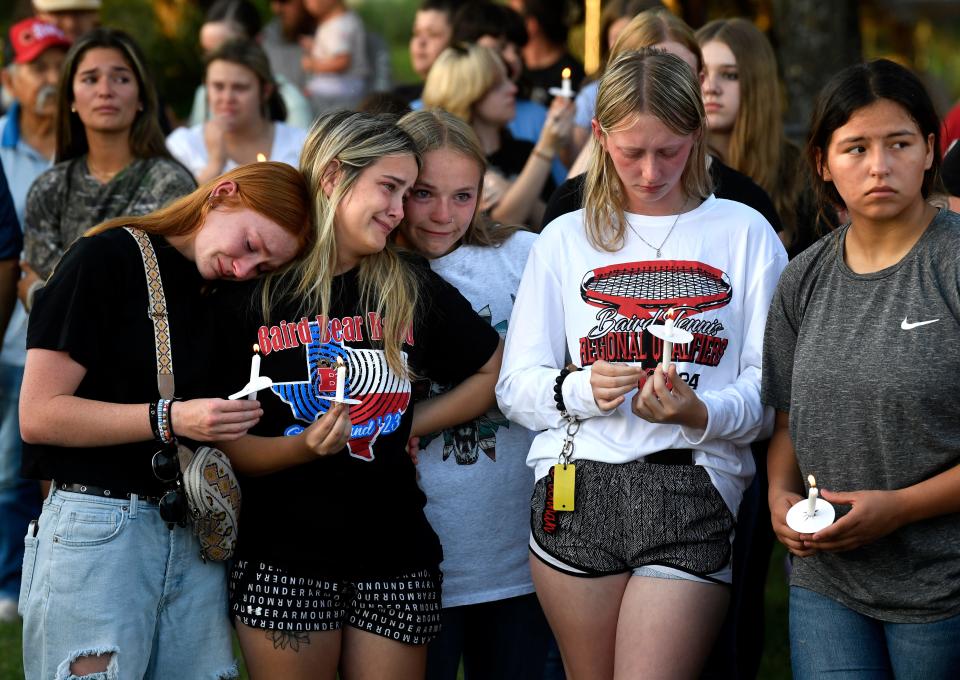 During a candlelight service May 7, friends and peers remember the three Baird teens killed earlier in the month.