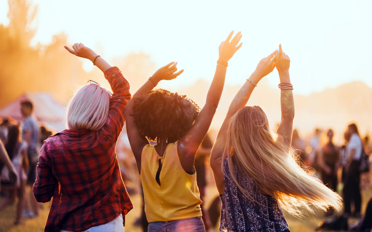 Multiethnic friends celebrating summer holi festival - Credit: leszekglasner/Adobe Stock