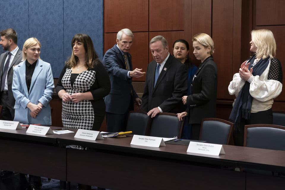 From left, Ukrainian Parliament members Yevheniya Kravchuk and Lesia Zaburanna, U.S. Sen. Rob Portman, R-Ohio, Sen. Dick Durbin, D-Ill., Ukrainian Amb. Oksana Markarova, Ukraine Parliament members Anastasia Radina, and Maria Ionova meet to discuss the ongoing Russian invasion of Ukraine, at the Capitol in Washington, Wednesday, March 30, 2022. (AP Photo/J. Scott Applewhite)