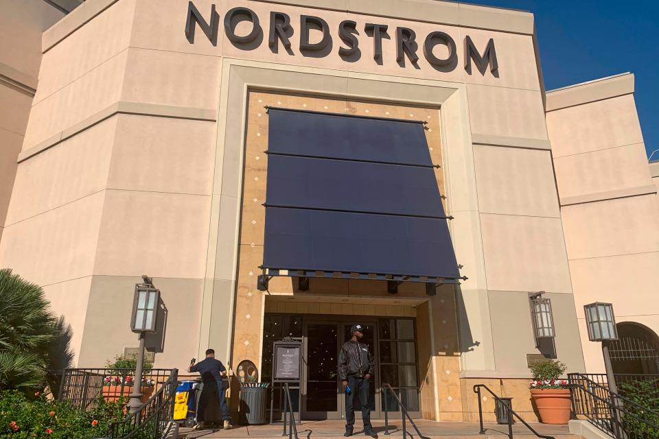 A security guard stands outside the Nordstrom store at The Grove retail and entertainment complex in Los Angeles.