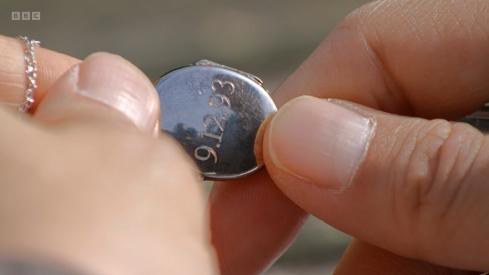 Silver locket with the date 9.12.93 engraved.