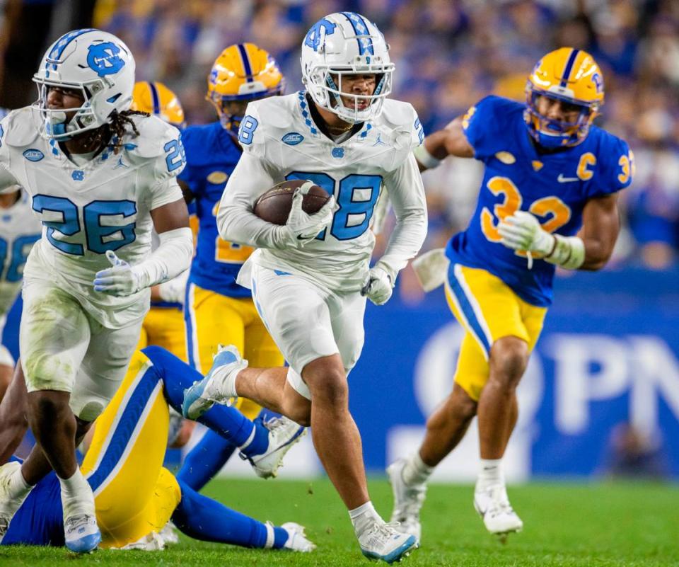 North Carolina’s Alijah Huzzie (28) returns a punt 52-yards for a touchdown in the second quarter to give the Tar Heels a 21-14 lead over Pitt in the second quarter on Saturday, September 23, 2023 at Acrisure Stadium in Pittsburgh, Pa.