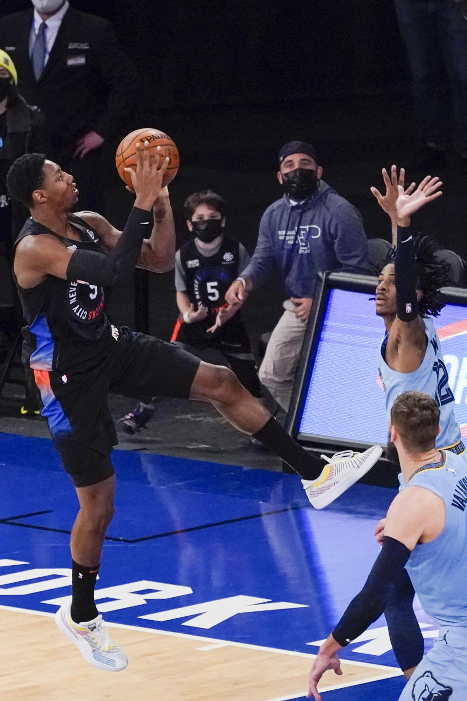 New York Knicks guard RJ Barrett (9) goes to the basket against Memphis Grizzlies guard Ja Morant to tie an NBA basketball game in the final seconds of the second half Friday, April 9, 2021, at Madison Square Garden in New York. (AP Photo/Mary Altaffer, Pool)