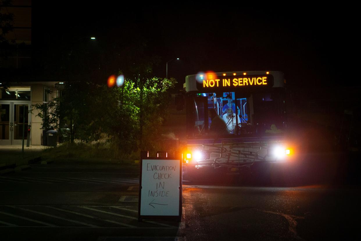 A bus carrying evacuees from the Oakridge area arrives at Lane Community College Friday, Sept. 9, 2022, in Eugene, Ore. 