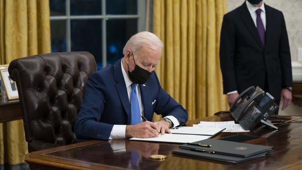 In this Tuesday, Feb. 2, 2021, file photo, Secretary of Homeland Security Alejandro Mayorkas looks on as President Joe Biden signs an executive order on immigration, in the Oval Office of the White House in Washington. (AP Photo/Evan Vucci, File)