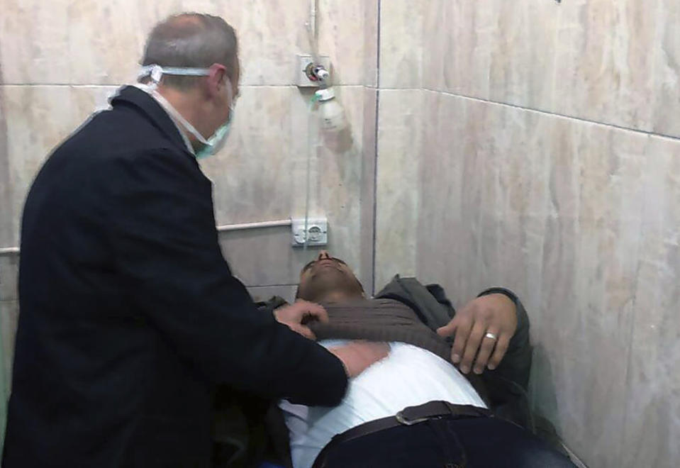 In this photo released by the Syrian official news agency SANA, shows a man receiving treatment at a hospital following a suspected chemical attack on his town of al-Khalidiya, in Aleppo, Syria, Saturday, Nov. 24, 2018. At least 41 civilians were being treated following a suspected poison gas attack by Syrian rebel groups on government-held Aleppo city in the country's north, according to Syrian state media. (SANA via AP)