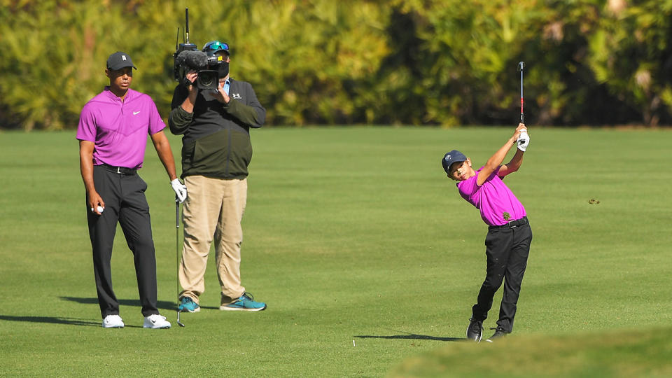 Charlie Woods hits a shot as Tiger Woods watches on during the first round of the PGA TOUR Champions PNC Championship at Ritz-Carlton Golf Club in Orlando, Florida. (Photo by Ben Jared/PGA TOUR via Getty Images)