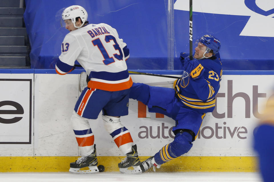 Buffalo Sabres forward Sam Reinhart (23) and New York Islanders forward Mathew Barzal (13) collide during the first period of an NHL hockey game, Monday, Feb. 15, 2021, in Buffalo, N.Y. (AP Photo/Jeffrey T. Barnes)