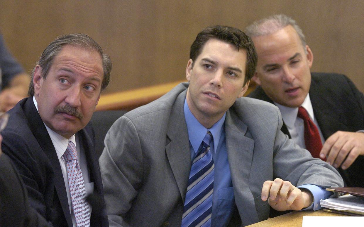 In this file photo, Scott Peterson, center, with defense attorneys Mark Geragos, left, and Pat Harris listens to judge Alfred A. Delucchi in a Redwood City, Calif., courtroom, Thursday, July 29, 2004. 