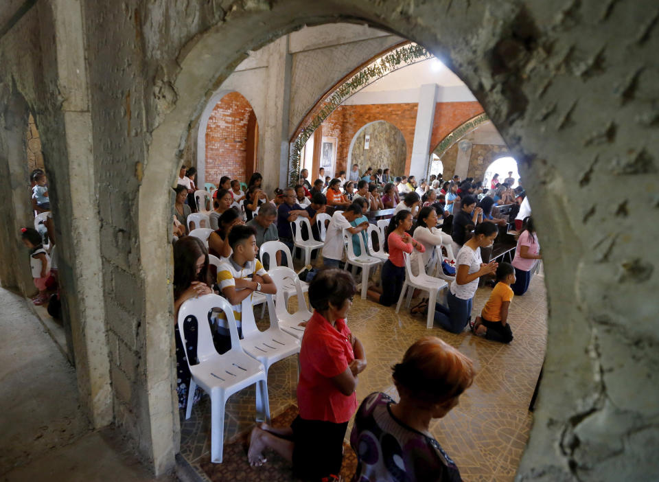 In this Jan. 27, 2019 photo, worshippers attend a Sunday Mass officiated by a substitute priest in the chapel built by U.S. priest Father Pius Hendricks in the village of Talustusan on Biliran Island in the central Philippines. Parishioners said Hendricks would ask children to occupy benches in front of the altar while saying Mass. (AP Photo/Bullit Marquez)