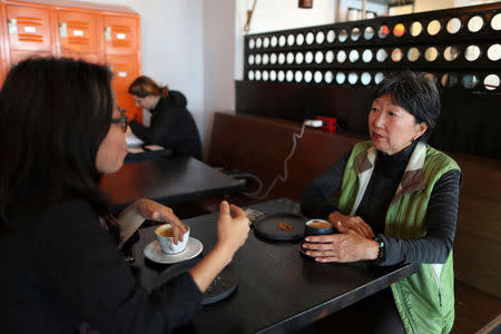 Angela Oh (R) talks to Grace Lee in a coffee shop in Koreatown, Los Angeles, California, April 27, 2018. REUTERS/Lucy Nicholson