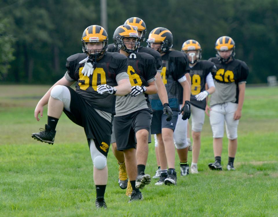 NORTH EASTHAM -- 08/29/22 -- Nicholas Voll, front, works through a warm up drill at the start of Monday's practice. Nauset Regional High School football is back in action. A practice was held Monday morning.  To see more photos, go to  www.capecodtimes.com/news/photo-galleries. Merrily Cassidy/Cape Cod Times