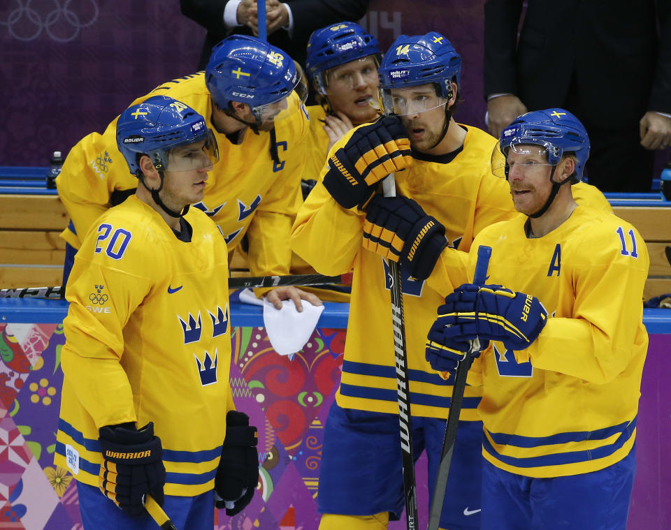 Sweden players talk during a break in the first period of a men's quarterfinal ice hockey game against Slovenia at the 2014 Winter Olympics, Wednesday, Feb. 19, 2014, in Sochi, Russia. (AP Photo/Mark Humphrey)
