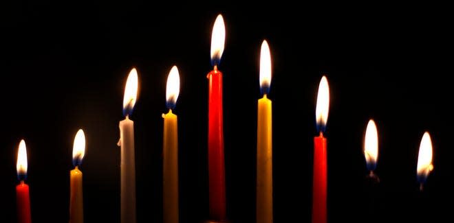 The candles of a menorah are lit for the Jewish festival of Hanukkah.