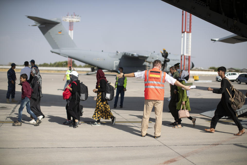 TASHKENT, UZBEKISTAN - AUGUST 22: In this handout image provided by the Bundeswehr, evacuees from Kabul arrive in Tashkent, on August 22, 2021 in Tashkent, Uzbekistan. German Chancellor Merkel said Germany must urgently evacuate up to 10,000 people from Afghanistan for which it is responsible. (Photo by Handout/Bundeswehr via Getty Images)