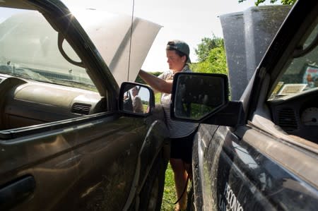 Layton Guenther, director of Quail Hill Farm, jump starts a pick-up truck in Amagansett