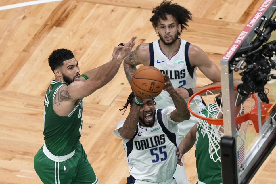 Dallas Mavericks forward Derrick Jones Jr. (55) shoots in front of Mavericks center Dereck Lively II (2) as Boston Celtics forward Jayson Tatum, left, defends during the first half of Game 5 of the NBA basketball finals, Monday, June 17, 2024, in Boston. (AP Photo/Michael Dwyer)