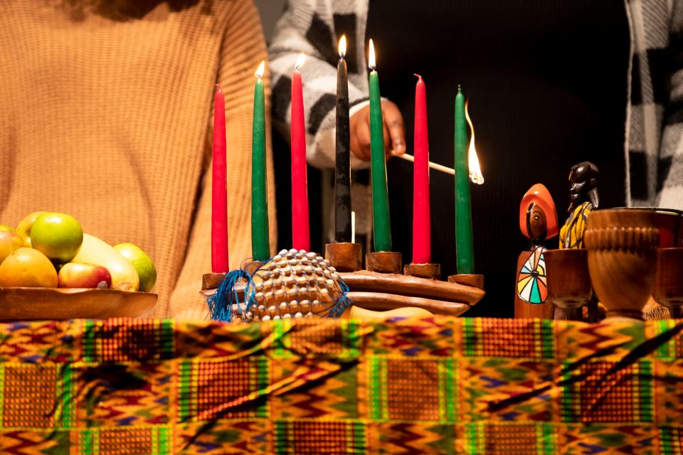 The Black Student Union leaders light candles for the Libation Ceremony during the Community Kwanzaa Celebration, Saturday, Dec. 4, 2021, at the University Union on the campus of UW-Green Bay in Green Bay, Wis. Samantha Madar/USA TODAY NETWORK-Wisconsin 