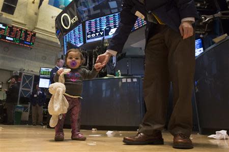 Farrah Kessler is helped by her father as she walks on the floor of the New York Stock Exchange November 29, 2013. REUTERS/Brendan McDermid